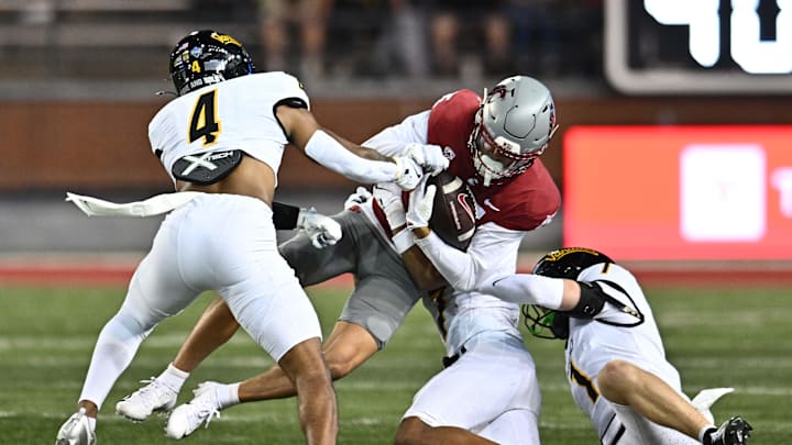 Aug 30, 2025; Pullman, Washington, USA; Washington State Cougars wide receiver Jeremiah Noga (15) is tackled by Idaho Vandals defensive back Aaron Kinsey (7) in the first half at Gesa Field at Martin Stadium. Mandatory Credit: James Snook-Imagn Images