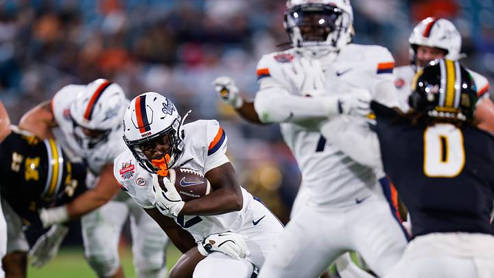 Virginia Cavaliers running back Xay Davis (25) drives up field during the second quarter of the TaxSlayer Gator Bowl at EverBank Stadium Saturday December 27, 2025 in Jacksonville, Fla. [Doug Engle/Florida Times-Union]