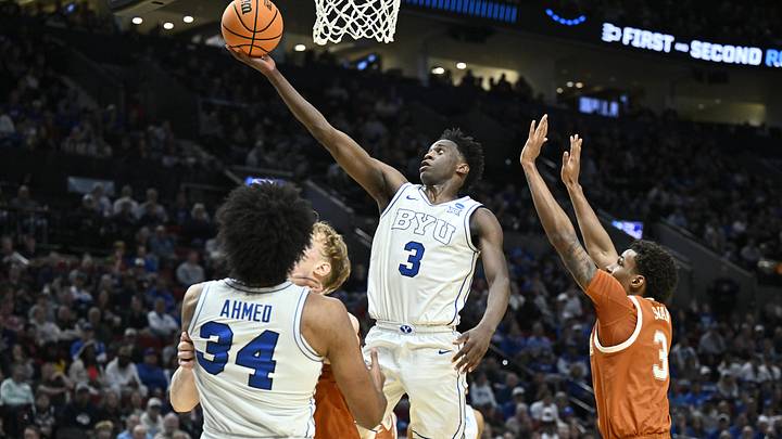 Mar 19, 2026; Portland, OR, USA; BYU Cougars forward AJ Dybantsa (3) shoots against Texas Longhorns forward Dailyn Swain (3) in the first half during a first round game of the men's 2026 NCAA Tournament at Moda Center. Mandatory Credit: Craig Strobeck-Imagn Images