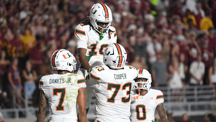 Oct 4, 2025; Tallahassee, Florida, USA; Miami Hurricanes wide receiver Malachi Toney (10) celebrates with teammates after scoring a touchdown during the second half against the Florida State Seminoles at Doak S. Campbell Stadium. Mandatory Credit: Robert Myers-Imagn Images