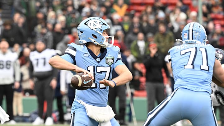 Dec 28, 2024; Boston, MA, USA; North Carolina Tar Heels quarterback Michael Merdinger (17) throws a pass against the Connecticut Huskies during the first half at Fenway Park. Mandatory Credit: Eric Canha-Imagn Images