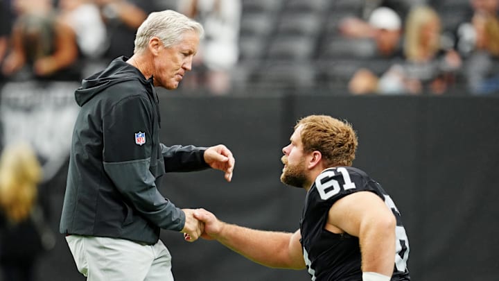 Oct 12, 2025; Paradise, Nevada, USA; Las Vegas Raiders guard Jordan Meredith (61) and Las Vegas Raiders head coach Pete Carroll talk before the game against the Tennessee Titans at Allegiant Stadium. Mandatory Credit: Stephen R. Sylvanie-Imagn Images Oct 12, 2025; Paradise, Nevada, USA; Las Vegas Raiders guard Jordan Meredith (61) and Las Vegas Raiders head coach Pete Carroll talk before the game against the Tennessee Titans at Allegiant Stadium. Mandatory Credit: Stephen R. Sylvanie-Imagn Images