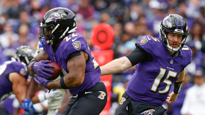 Oct 12, 2025; Baltimore, Maryland, USA; Baltimore Ravens quarterback Cooper Rush (15) hands the ball to running back Derrick Henry (22) against the Los Angeles Rams during the first quarter of the game at M&T Bank Stadium. Mandatory Credit: Peter Casey-Imagn Images Oct 12, 2025; Baltimore, Maryland, USA; Baltimore Ravens quarterback Cooper Rush (15) hands the ball to running back Derrick Henry (22) against the Los Angeles Rams during the first quarter of the game at M&T Bank Stadium. Mandatory Credit: Peter Casey-Imagn Images
