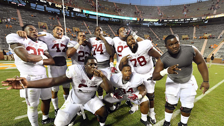 Oct 15, 2016; Knoxville, TN, USA;  Alabama Crimson Tide players celebrate their 49-10 victory with a traditional victory cigar after defeating the Tennessee Volunteers at Neyland Stadium. Mandatory Credit: John David Mercer-Imagn Images
