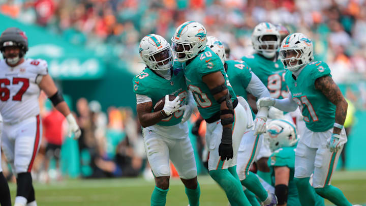 Dec 28, 2025; Miami Gardens, Florida, USA; Miami Dolphins cornerback Jason Marshall Jr. (33) celebrates with linebacker Jordyn Brooks (20) following an interception during the second quarter against the Tampa Bay Buccaneers at Hard Rock Stadium. Mandatory Credit: Sam Navarro-Imagn Images