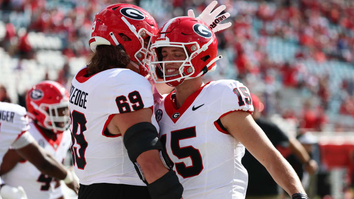 Oct 28, 2023; Jacksonville, Florida, USA; Georgia Bulldogs quarterback Carson Beck (15) and offensive lineman Tate Ratledge (69) hug prior to the game against the Florida Gators at EverBank Stadium. Mandatory Credit: Kim Klement Neitzel-USA TODAY Sports Oct 28, 2023; Jacksonville, Florida, USA; Georgia Bulldogs quarterback Carson Beck (15) and offensive lineman Tate Ratledge (69) hug prior to the game against the Florida Gators at EverBank Stadium. Mandatory Credit: Kim Klement Neitzel-USA TODAY Sports
