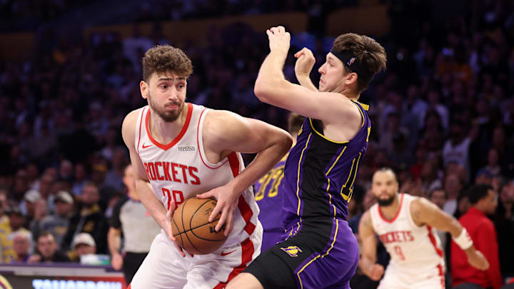 Houston Rockets center Alperen Sengun goes to the basket against Los Angeles Lakers guard Austin Reaves.