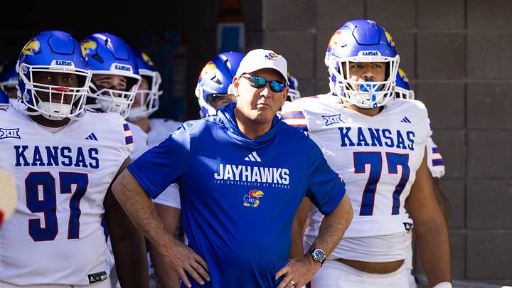 Nov 8, 2025; Tucson, Arizona, USA; Kansas Jayhawks head coach Lance Leipold (center) with defensive tackle Kenean Caldwell (97) and offensive lineman Enrique Cruz Jr. (77) against the Arizona Wildcats at Arizona Stadium. Mandatory Credit: Mark J. Rebilas-Imagn Images