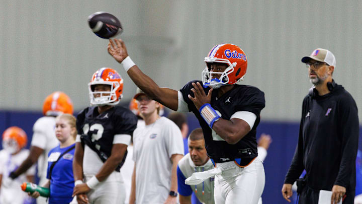 Florida Gators quarterback DJ Lagway (2) throws the ball while Florida Gators assistant coach for quarterbacks Ryan O'Hara looks on during fall football practice at Sanders Indoor Practice Fields at the University of Florida in Gainesville, FL on Thursday, August 7, 2025. [Matt Pendleton/Gainesville Sun]