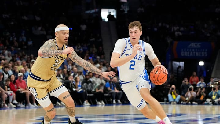 Mar 13, 2025; Charlotte, NC, USA; Duke Blue Devils forward Cooper Flagg (2) with the ball as Georgia Tech Yellow Jackets forward Duncan Powell (31) defends in the first half at Spectrum Center. Mandatory Credit: Bob Donnan-Imagn Images
