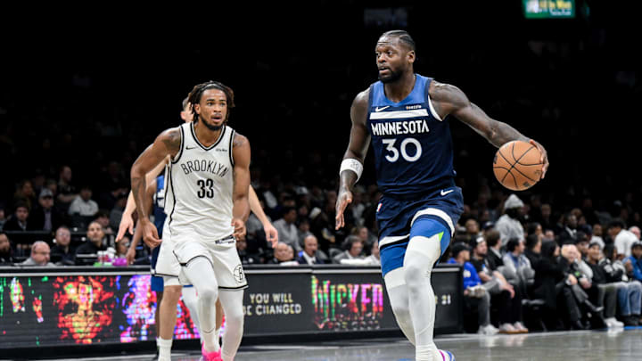 Nov 3, 2025; Brooklyn, New York, USA; Minnesota Timberwolves forward Julius Randle (30) looks to drive against Brooklyn Nets center Nic Claxton (33) during the first half at Barclays Center. Mandatory Credit: John Jones-Imagn Images