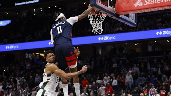 Dec 1, 2025; Washington, District of Columbia, USA; Washington Wizards guard Bilal Coulibaly (0) is fouled while dunking the ball by Milwaukee Bucks forward Giannis Antetokounmpo (34) in the final se bonds in the fourth quarter at Capital One Arena. Mandatory Credit: Geoff Burke-Imagn Images