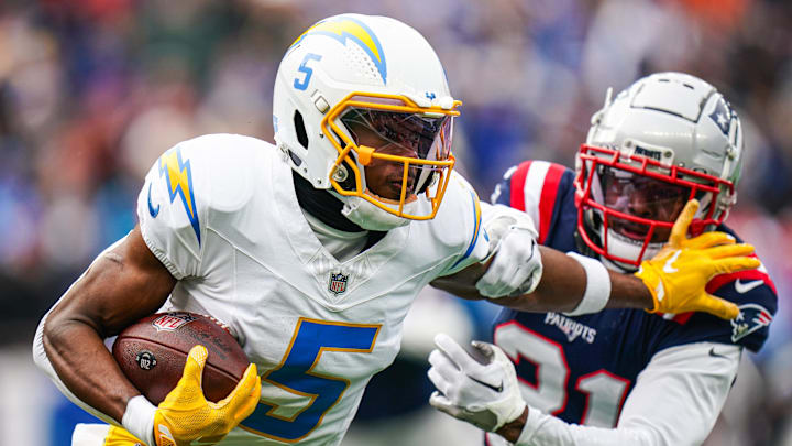 Dec 28, 2024; Foxborough, Massachusetts, USA; Los Angeles Chargers wide receiver Joshua Palmer (5) runs the ball against New England Patriots cornerback Jonathan Jones (31) in the first quarter at Gillette Stadium. Mandatory Credit: David Butler II-Imagn Images