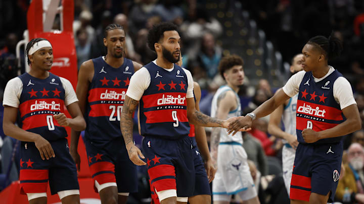 Dec 26, 2024; Washington, District of Columbia, USA; Washington Wizards forward Justin Champagnie (9) celebrates with Wizards guard Bub Carrington (8) during a timeout in the final seconds against the Charlotte Hornets in the fourth quarter at Capital One Arena. Mandatory Credit: Geoff Burke-Imagn Images