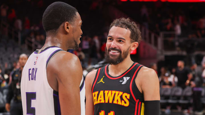 Nov 1, 2024; Atlanta, Georgia, USA; Sacramento Kings guard De'Aaron Fox (5) talks to Atlanta Hawks guard Trae Young (11) after a game at State Farm Arena. Mandatory Credit: Brett Davis-Imagn Images