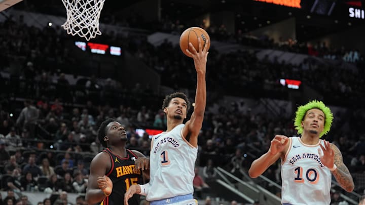 Dec 19, 2024; San Antonio, Texas, USA;  San Antonio Spurs center Victor Wembanyama (1) rebounds in front of Atlanta Hawks center Clint Capela (15) in the second half at Frost Bank Center. Mandatory Credit: Daniel Dunn-Imagn Images