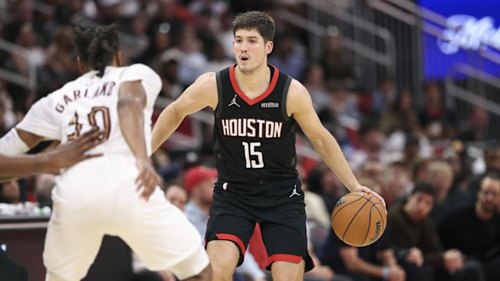 Dec 27, 2025; Houston, Texas, USA;  Houston Rockets guard Reed Sheppard (15) controls the ball as Cleveland Cavaliers guard Darius Garland (10) defends during the third quarter at Toyota Center. Mandatory Credit: Troy Taormina-Imagn Images