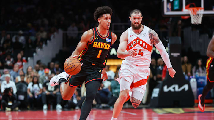 Nov 7, 2025; Atlanta, Georgia, USA; Atlanta Hawks forward Jalen Johnson (1) drives past Toronto Raptors forward Sandro Mamukelashvili (54) in the second quarter at State Farm Arena. Mandatory Credit: Brett Davis-Imagn Images
