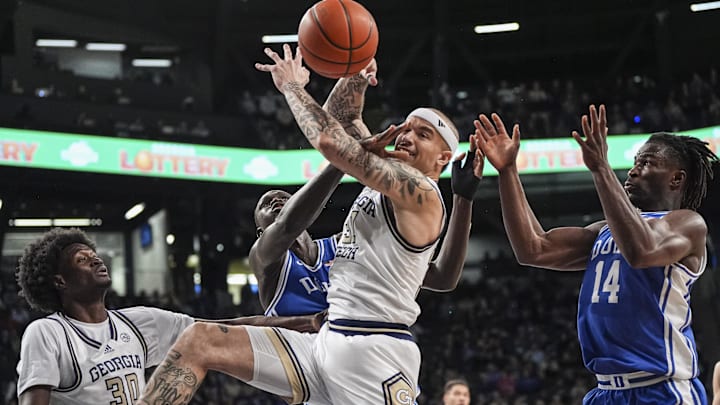 Dec 21, 2024; Atlanta, Georgia, USA; Duke Blue Devils center Khaman Maluach (9) and Georgia Tech Yellow Jackets forward Duncan Powell (31) fight for the ball during the first half at McCamish Pavilion. Mandatory Credit: Dale Zanine-Imagn Images