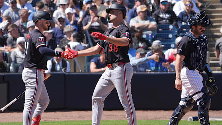 Mar 6, 2025; Tampa, Florida, USA; Minnesota Twins outfielder Matt Wallner (38) is congratulated at the plate by catcher Ryan Jeffers (27) as New York Yankees catcher Austin Wells (28) walks away during the second inning at George M. Steinbrenner Field. Mandatory Credit: Dave Nelson-Imagn Images