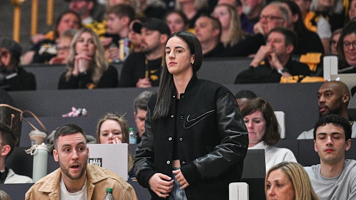 Feb 2, 2025; Iowa City, Iowa, USA; Former Iowa Hawkeyes player Caitlin Clark (center) looks on during the game between the Iowa Hawkeyes and the USC Trojans at Carver-Hawkeye Arena. Mandatory Credit: Jeffrey Becker-Imagn Images