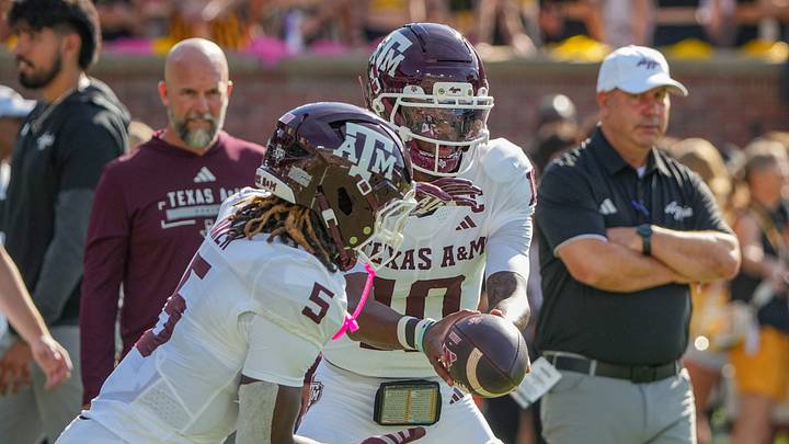 Oct 10, 2026; Columbia, Missouri, USA; Texas A&M Aggies quarterback Marcel Reed (10) hands off to running back Carsyn Baker (5) against the Missouri Tigers prior to a game at Faurot Field at Memorial Stadium. Mandatory Credit: Denny Medley-Imagn Images Oct 10, 2026; Columbia, Missouri, USA; Texas A&M Aggies quarterback Marcel Reed (10) hands off to running back Carsyn Baker (5) against the Missouri Tigers prior to a game at Faurot Field at Memorial Stadium. Mandatory Credit: Denny Medley-Imagn Images
