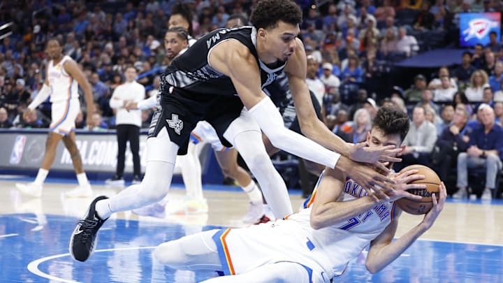 Oct 30, 2024; Oklahoma City, Oklahoma, USA: San Antonio Spurs center Victor Wembanyama (1) works to steal the ball from Oklahoma City Thunder forward Chet Holmgren (7) after he fell to the floor during the second half at Paycom Center. Mandatory Credit: Alonzo Adams-Imagn Images