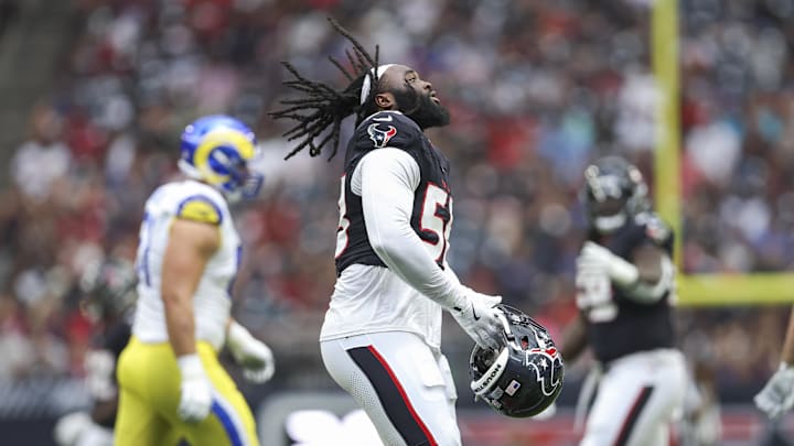 Aug 24, 2024; Houston, Texas, USA; Houston Texans defensive tackle McTelvin Agim (58) picks up his helmet after a play during the game against the Los Angeles Rams at NRG Stadium. Mandatory Credit: Troy Taormina-Imagn Images
