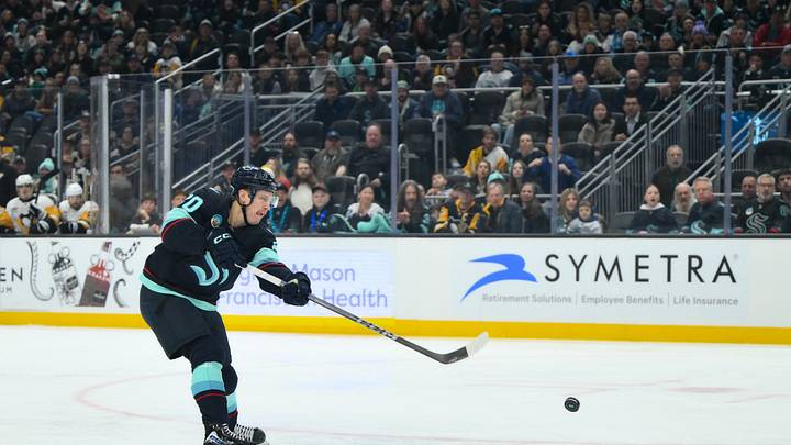 Jan 19, 2026; Seattle, Washington, USA; Seattle Kraken right wing Eeli Tolvanen (20) shoots the puck against the Pittsburgh Penguins during the first period at Climate Pledge Arena. Mandatory Credit: Steven Bisig-Imagn Images
