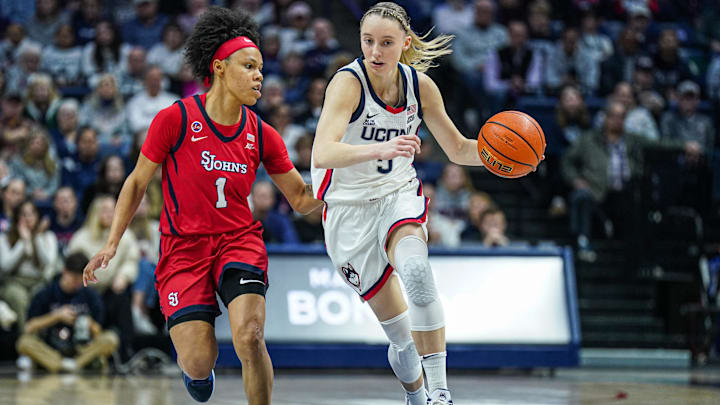 Feb 12, 2025; Storrs, Connecticut, USA; UConn Huskies guard Paige Bueckers (5) returns the ball against St. John's Red Storm guard Ariana Vanderhoop (1) in the first half at Harry A. Gampel Pavilion. Mandatory Credit: David Butler II-Imagn Images