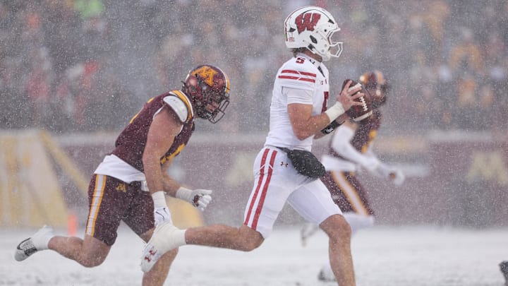 Nov 29, 2025; Minneapolis, Minnesota, USA; Wisconsin Badgers quarterback Carter Smith (5) runs with the ball against the Minnesota Golden Gophers during the first half at Huntington Bank Stadium. Nov 29, 2025; Minneapolis, Minnesota, USA; Wisconsin Badgers quarterback Carter Smith (5) runs with the ball against the Minnesota Golden Gophers during the first half at Huntington Bank Stadium.