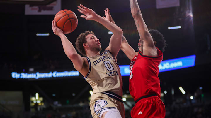 Mar 1, 2025; Atlanta, Georgia, USA; Georgia Tech Yellow Jackets guard Lance Terry (0) shoots past North Carolina State Wolfpack guard Dontrez Styles (3) in the second half at McCamish Pavilion. Mandatory Credit: Brett Davis-Imagn Images