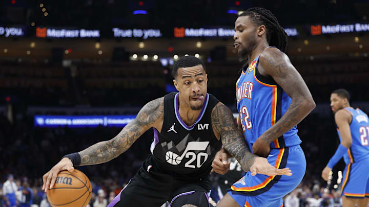 Jan 22, 2025; Oklahoma City, Oklahoma, USA; Utah Jazz forward John Collins (20) drives against Oklahoma City Thunder guard Cason Wallace (22) during the second half at Paycom Center. Mandatory Credit: Alonzo Adams-Imagn Images
