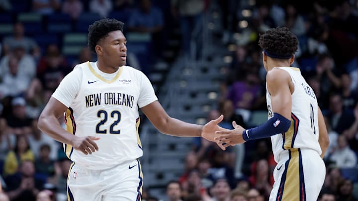 Dec 26, 2025; New Orleans, Louisiana, USA;  New Orleans Pelicans center Derik Queen (22) celebrates a basket with guard Jeremiah Fears (0) during the first half against the Phoenix Suns at Smoothie King Center. Mandatory Credit: Matthew Hinton-Imagn Images