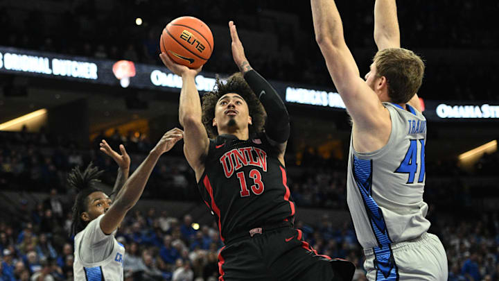 Dec 7, 2024; Omaha, Nebraska, USA; UNLV Rebels guard Brooklyn Hicks (13) attempts a shot against Creighton Bluejays forward Isaac Traudt (41) in the first half at CHI Health Center Omaha. Mandatory Credit: Steven Branscombe-Imagn Images Dec 7, 2024; Omaha, Nebraska, USA; UNLV Rebels guard Brooklyn Hicks (13) attempts a shot against Creighton Bluejays forward Isaac Traudt (41) in the first half at CHI Health Center Omaha. Mandatory Credit: Steven Branscombe-Imagn Images