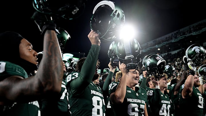 Oct 19, 2024; East Lansing, Michigan, USA; Michigan State Spartans place kicker Jonathan Kim (97) sings with his team as he celebrates kicking six field goals against the Iowa Hawkeyes at Spartan Stadium. Mandatory Credit: Dale Young-Imagn Images Oct 19, 2024; East Lansing, Michigan, USA; Michigan State Spartans place kicker Jonathan Kim (97) sings with his team as he celebrates kicking six field goals against the Iowa Hawkeyes at Spartan Stadium. Mandatory Credit: Dale Young-Imagn Images