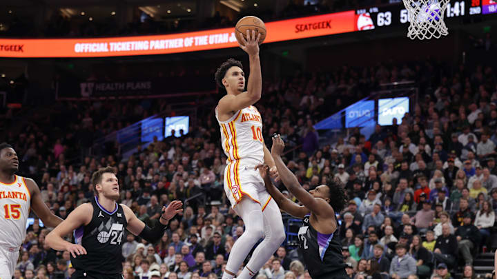 Jan 7, 2025; Salt Lake City, Utah, USA;  Atlanta Hawks forward Zaccharie Risacher (10) shoots the ball over Utah Jazz guard Collin Sexton (2) during the second quarter at Delta Center. Mandatory Credit: Chris Nicoll-Imagn Images