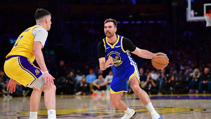 Feb 7, 2026; Los Angeles, California, USA; Golden State Warriors guard Pat Spencer (61) controls the ball against Los Angeles Lakers forward Jake LaRavia (12) during the second half at Crypto.com Arena. Mandatory Credit: Gary A. Vasquez-Imagn Images