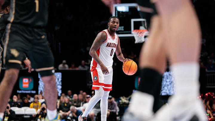 Mar 12, 2026; Kansas City, MO, USA; Arizona Wildcats guard Jaden Bradley (0) brings the ball up court during the first half against the UCF Knights at T-Mobile Center. Mandatory Credit: William Purnell-Imagn Images