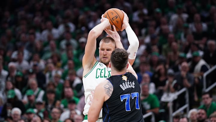 Jun 6, 2024; Boston, Massachusetts, USA; Boston Celtics center Kristaps Porzingis (8) controls the ball against Dallas Mavericks guard Luka Doncic (77) in the third quarter during game one of the 2024 NBA Finals at TD Garden. Mandatory Credit: David Butler II-USA TODAY Sports Jun 6, 2024; Boston, Massachusetts, USA; Boston Celtics center Kristaps Porzingis (8) controls the ball against Dallas Mavericks guard Luka Doncic (77) in the third quarter during game one of the 2024 NBA Finals at TD Garden. Mandatory Credit: David Butler II-USA TODAY Sports