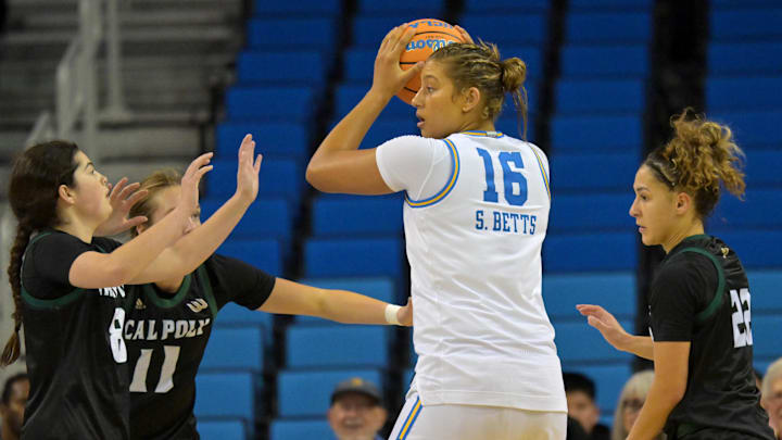 Dec 16, 2025; Los Angeles, California, USA; UCLA Bruins forward Sienna Betts (16) is defended by Cal Poly Mustangs guard Katie Peiffer (8), forward Avery Knapp (11) and guard Alana Goosby (22) during the second half at Pauley Pavilion presented by Wescom Financial. Mandatory Credit: Jayne Kamin-Oncea-Imagn Images