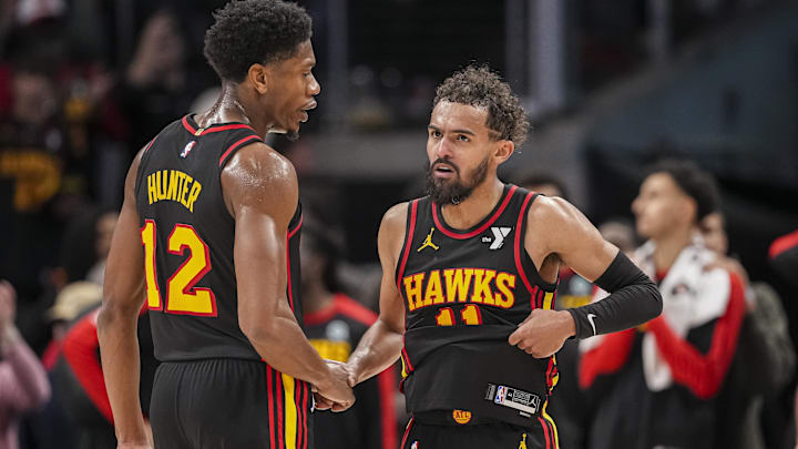 Dec 28, 2024; Atlanta, Georgia, USA; Atlanta Hawks guard Trae Young (11) reacts with forward De'Andre Hunter (12) after the Hawks defeated the Miami Heat at State Farm Arena. Mandatory Credit: Dale Zanine-Imagn Images