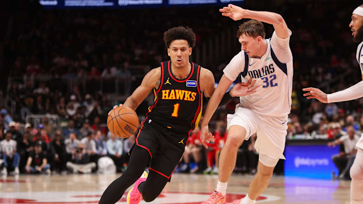 Mar 10, 2026; Atlanta, Georgia, USA; Atlanta Hawks forward Jalen Johnson (1) drives on Dallas Mavericks forward Cooper Flagg (32) in the fourth quarter at State Farm Arena. Mandatory Credit: Brett Davis-Imagn Images
