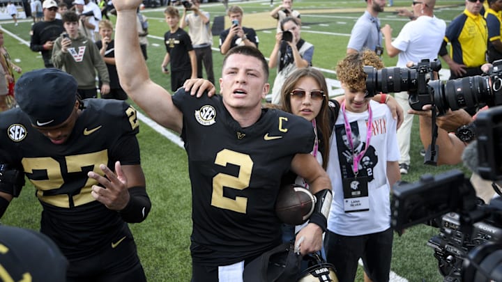 Oct 18, 2025; Nashville, Tennessee, USA;  Vanderbilt Commodores quarterback Diego Pavia (2) celebrates the win with the student section against the Louisiana State Tigers during the second half at FirstBank Stadium. Mandatory Credit: Steve Roberts-Imagn Images