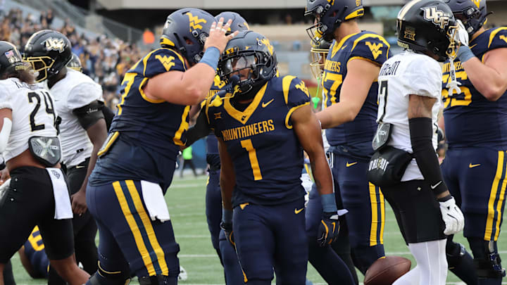 West Virginia University running back Jahiem White celebrates his three-yard touchdown run in the first quarter. West Virginia University running back Jahiem White celebrates his three-yard touchdown run in the first quarter.