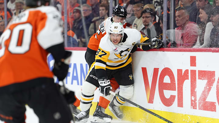 Apr 29, 2026; Philadelphia, Pennsylvania, USA; Pittsburgh Penguins center Sidney Crosby (87) reaches for the puck against Philadelphia Flyers defenseman Rasmus Ristolainen (55) in the second period in game six of the first round of the 2026 Stanley Cup Playoffs at Xfinity Mobile Arena. Mandatory Credit: Kyle Ross-Imagn Images