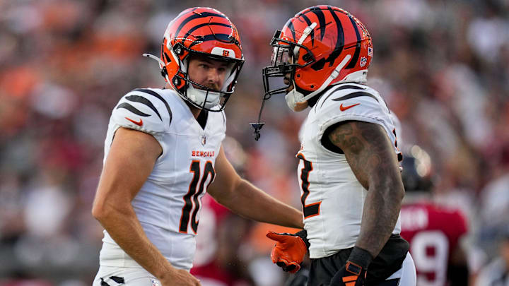 Cincinnati Bengals punter Brad Robbins (10) cheers on running back Trayveon Williams (32) for a deep stop on a punt return in the second quarter of the NFL Preseason Week 1 game between the Cincinnati Bengals and the Tampa Bay Buccaneers at Paycor Stadium in downtown Cincinnati on Saturday, Aug. 10, 2024.