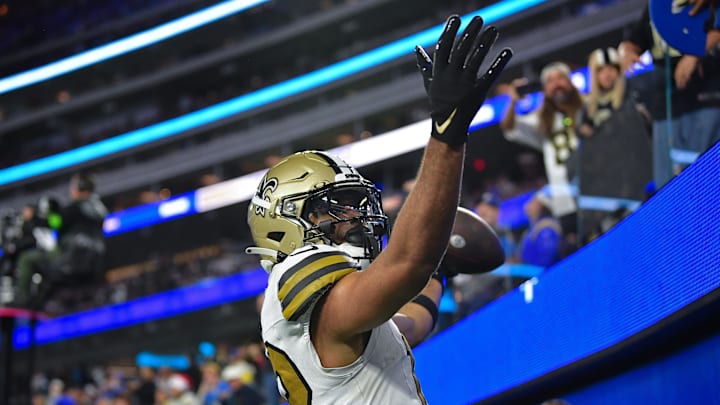 Dec 21, 2023; Inglewood, California, USA; New Orleans Saints wide receiver Chris Olave (12) celebrates after scoring on two point conversion against the Los Angeles Rams during the second half at SoFi Stadium. Mandatory Credit: Gary A. Vasquez-Imagn Images