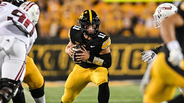 Sep 13, 2025; Iowa City, Iowa, USA; Iowa Hawkeyes quarterback Mark Gronowski (11) scrambles with the ball during the second quarter against the Massachusetts Minutemen at Kinnick Stadium. Mandatory Credit: Jeffrey Becker-Imagn Images