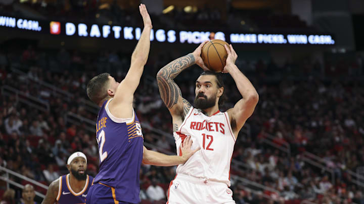 Dec 5, 2025; Houston, Texas, USA; Houston Rockets center Steven Adams (12) controls the ball as Phoenix Suns guard Collin Gillespie (12) defends during the first half at Toyota Center. Mandatory Credit: Troy Taormina-Imagn Images Dec 5, 2025; Houston, Texas, USA; Houston Rockets center Steven Adams (12) controls the ball as Phoenix Suns guard Collin Gillespie (12) defends during the first half at Toyota Center. Mandatory Credit: Troy Taormina-Imagn Images
